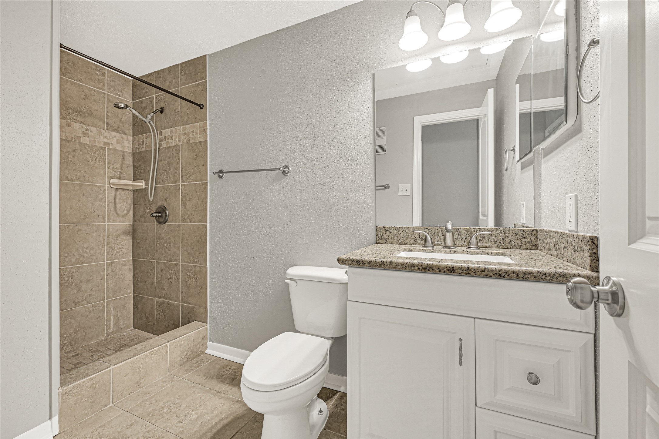 2425 Augusta Drive, Unit 29 Houston, TX 77057 - Photo 11 of 23 a bathroom with a granite countertop sink toilet a mirror and shower