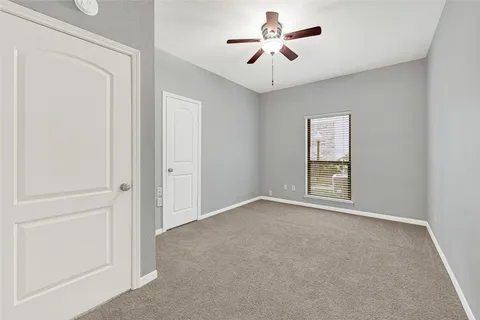 a bedroom with a bed couch and window