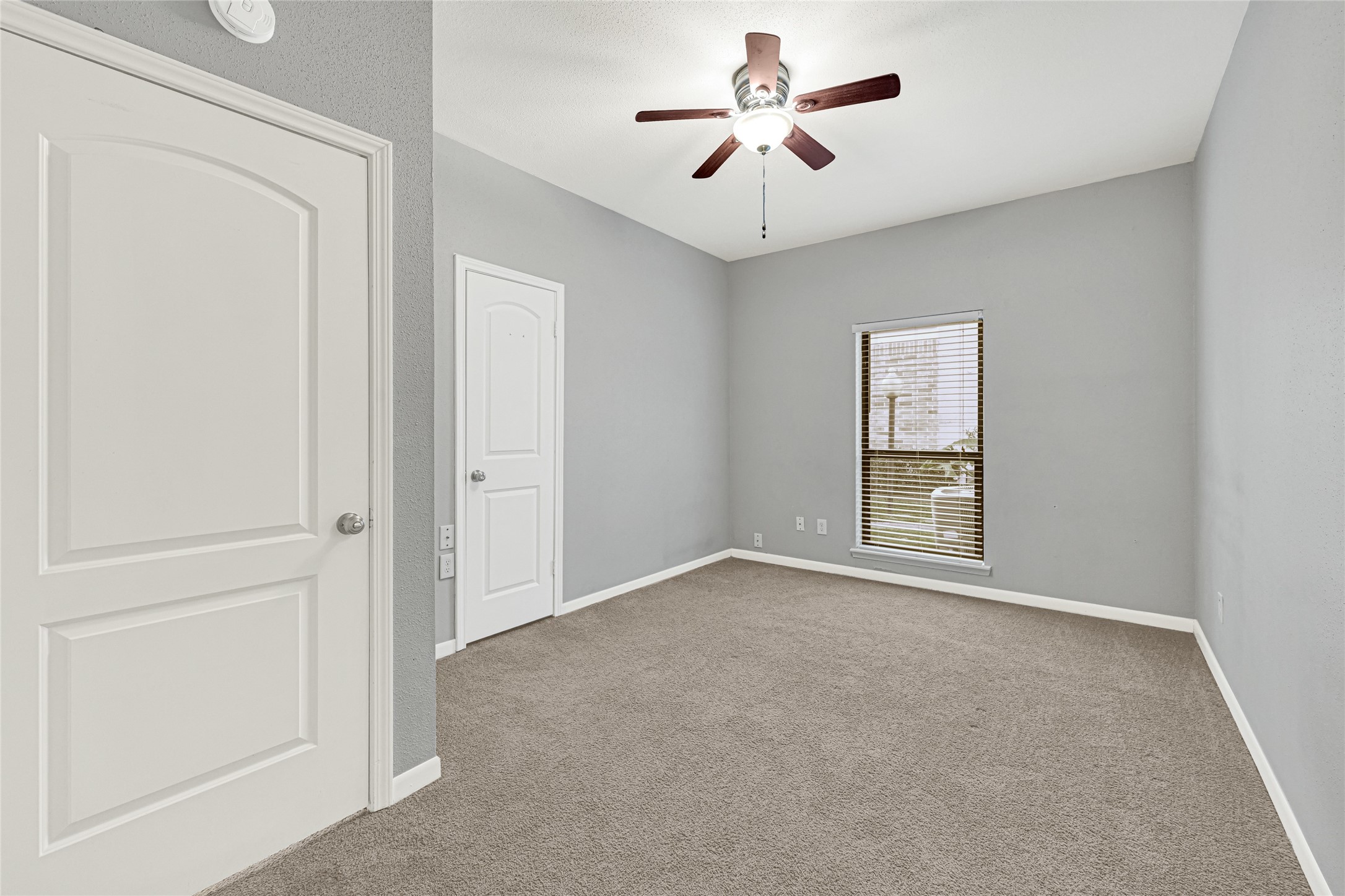 2425 Augusta Drive, Unit 29 Houston, TX 77057 - Photo 15 of 30 an empty room with windows and fan