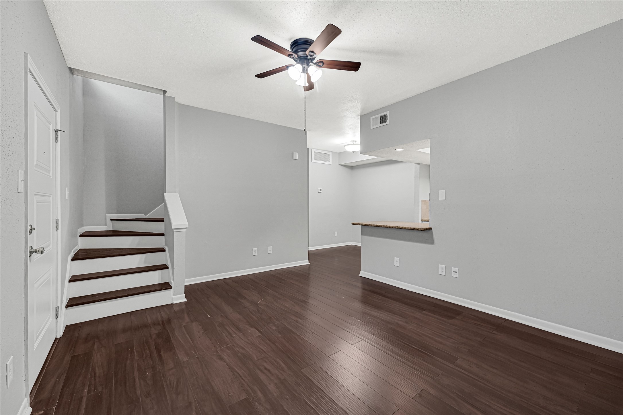 2425 Augusta Drive, Unit 29 Houston, TX 77057 - Photo 3 of 23 an empty room with wooden floor and a ceiling fan