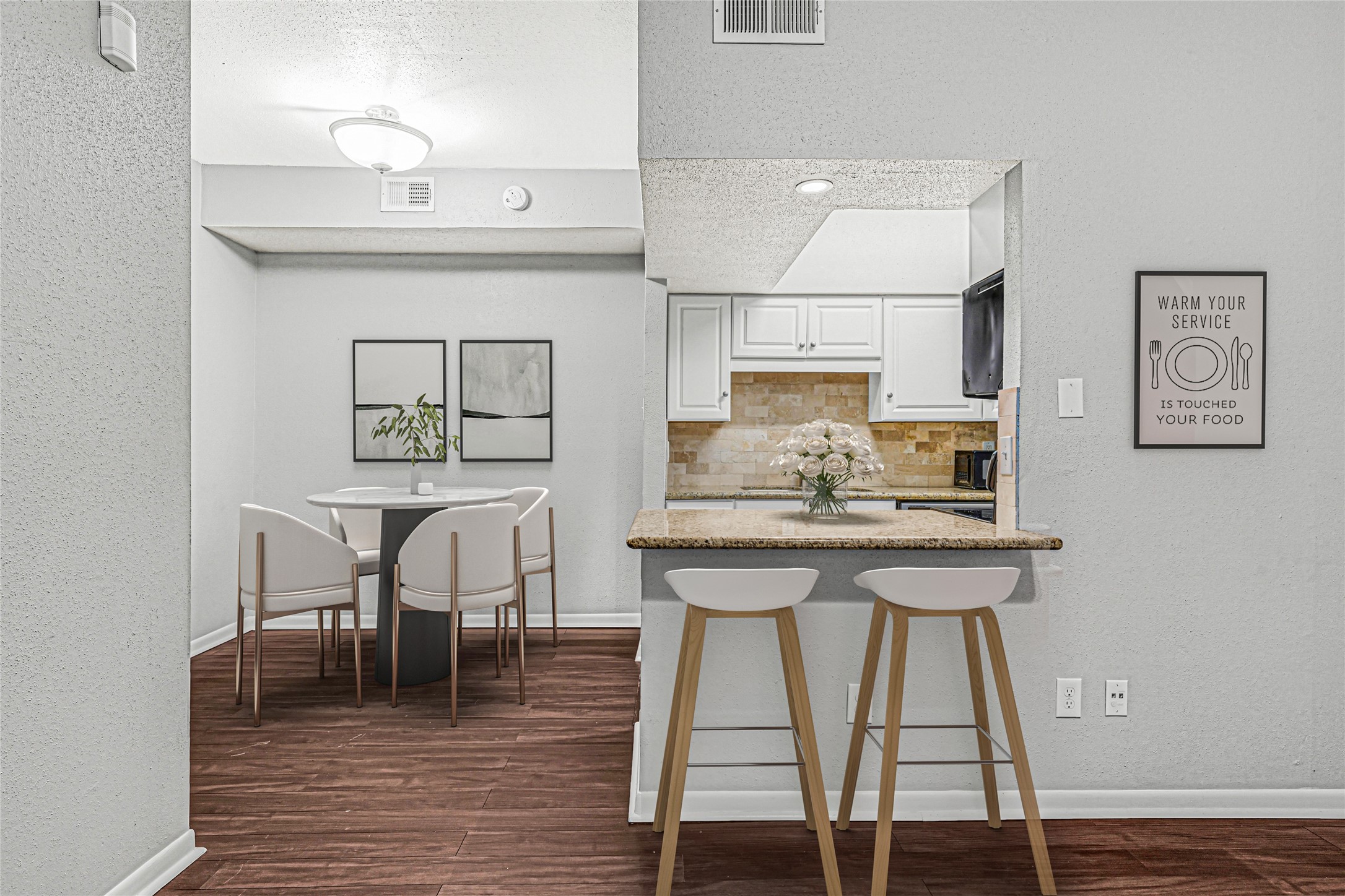 2425 Augusta Drive, Unit 29 Houston, TX 77057 - Photo 7 of 30 a view of a dining room with furniture and wooden floor