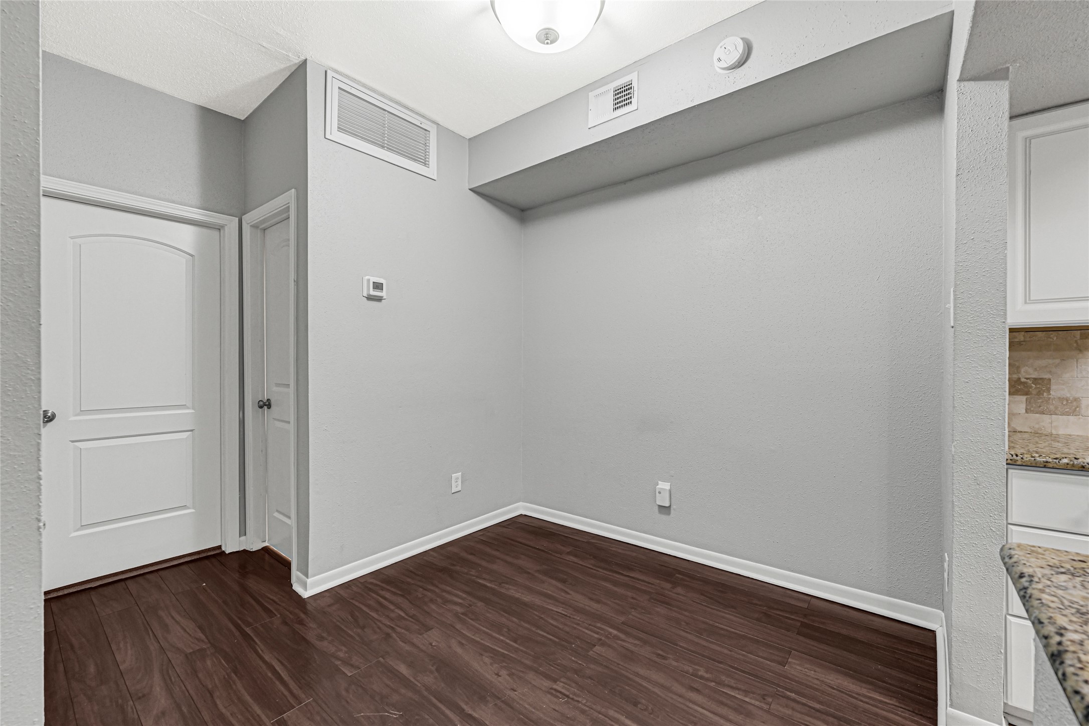 2425 Augusta Drive, Unit 29 Houston, TX 77057 - Photo 10 of 30 a view of an empty room with wooden floor