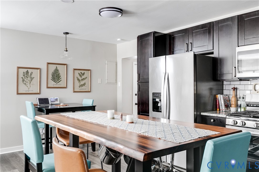 2815 Caniff Road Richmond, VA 23223 - Photo 14 of 39 a dining room with stainless steel appliances a table and chairs