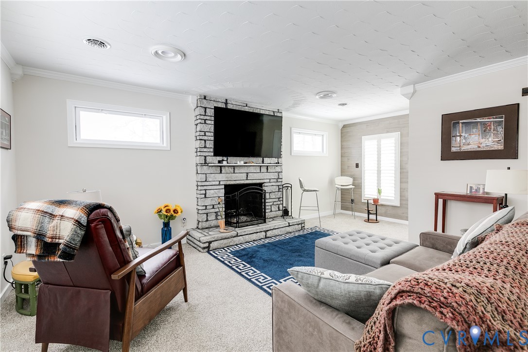 2815 Caniff Road Richmond, VA 23223 - Photo 22 of 39 a living room with furniture a flat screen tv and a fireplace