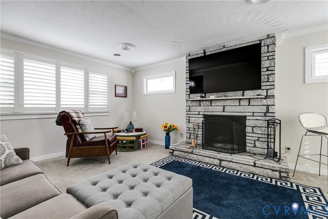2815 Caniff Road Richmond, VA 23223 - Photo 23 of 39 a living room with furniture a flat screen tv and a fireplace