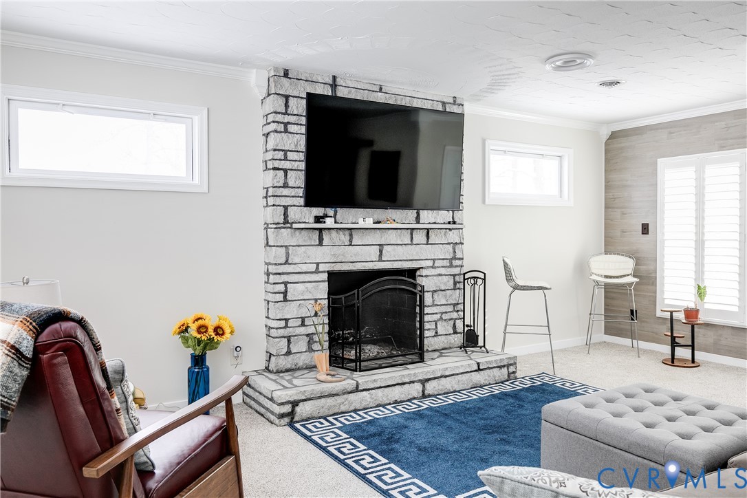 2815 Caniff Road Richmond, VA 23223 - Photo 25 of 39 a living room with furniture a flat screen tv and a fireplace
