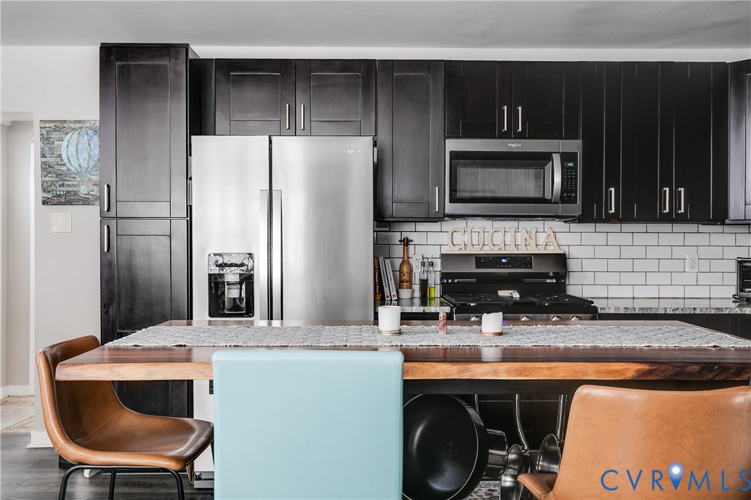 2815 Caniff Road Richmond, VA 23223 - Photo 10 of 39 a kitchen with stainless steel appliances a sink a stove a microwave a refrigerator and cabinets