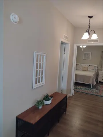 a bedroom with furniture and a chandelier