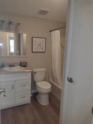 a bedroom with a bed and painting on the wall