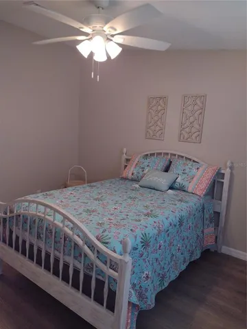 a spacious bedroom with a bed and a mirror