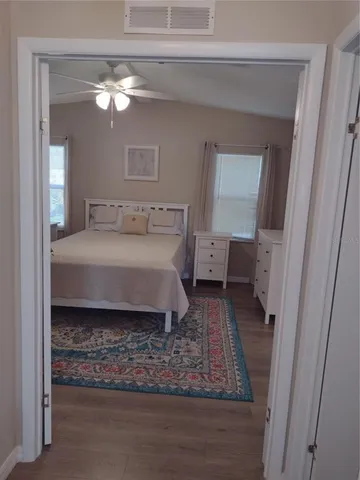 a bedroom with a bed and a chandelier