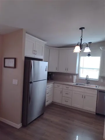a kitchen with a sink stove and refrigerator