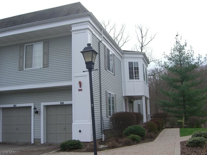 177 Riveredge Drive Chatham, NJ 07928 - Photo 2 of 17 a front view of a house with garden