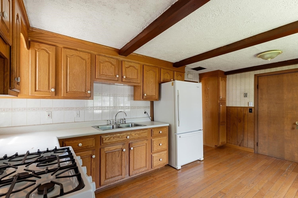 19 Butler Avenue Wakefield, MA 01880 - Photo 16 of 33 a kitchen with a refrigerator and a sink