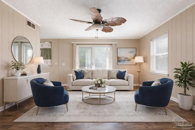 a living room with furniture a rug potted plant and a large window