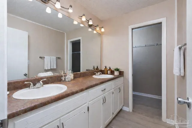 a bathroom with a sink double vanity and a mirror