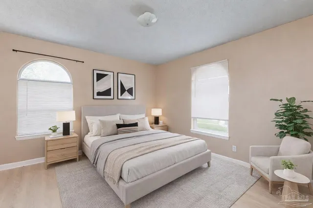 a bedroom with a bed and a painting on the wall