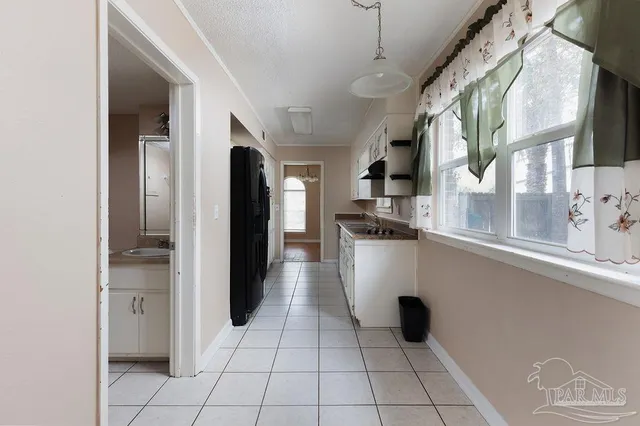 a view of a kitchen with a refrigerator and a stove