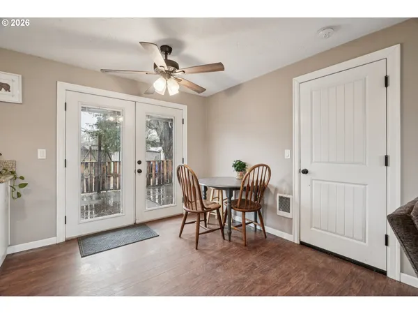 a dining room with furniture a chandelier and wooden floor
