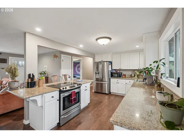 a kitchen with stainless steel appliances a stove a sink dishwasher and a refrigerator