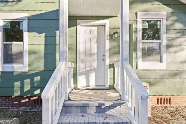 a view of a balcony with wooden floor and floor to ceiling window