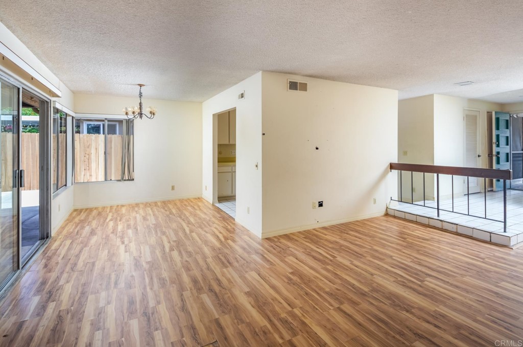 141 Solace Court Encinitas, CA 92024 - Photo 11 of 19 a view of empty room with wooden floor and fan