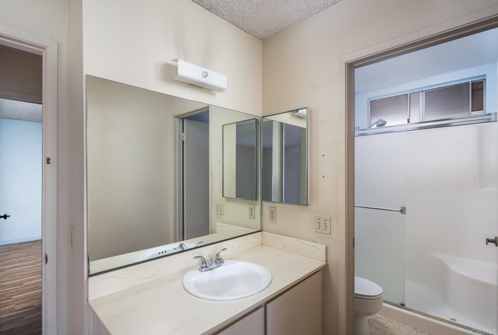 141 Solace Court Encinitas, CA 92024 - Photo 14 of 19 a bathroom with a sink toilet and shower