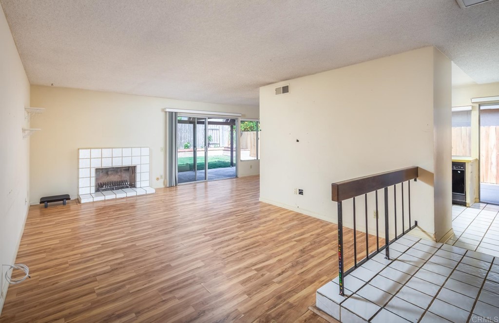 141 Solace Court Encinitas, CA 92024 - Photo 8 of 19 a view of a livingroom with wooden floor and staircase