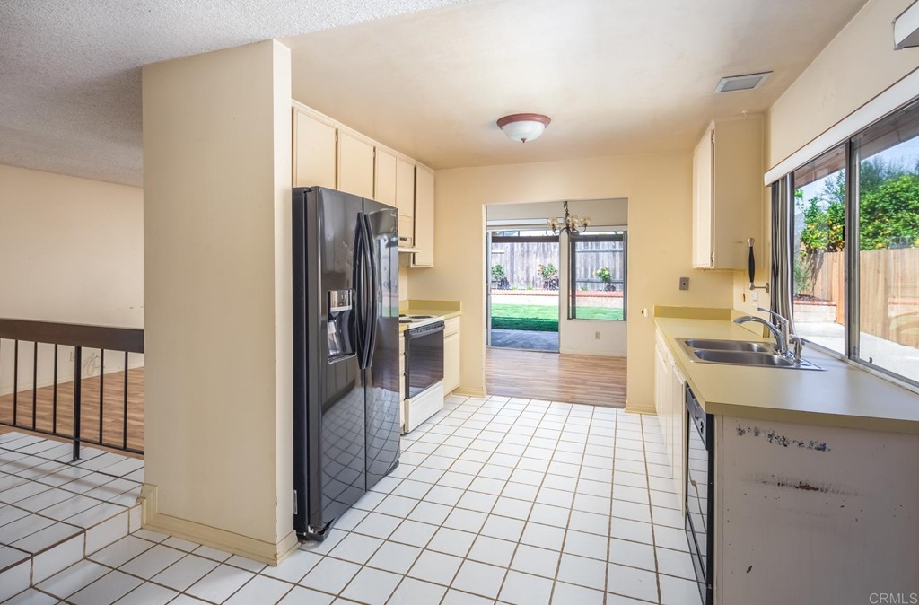 141 Solace Court Encinitas, CA 92024 - Photo 9 of 19 a kitchen with stainless steel appliances a refrigerator and a sink