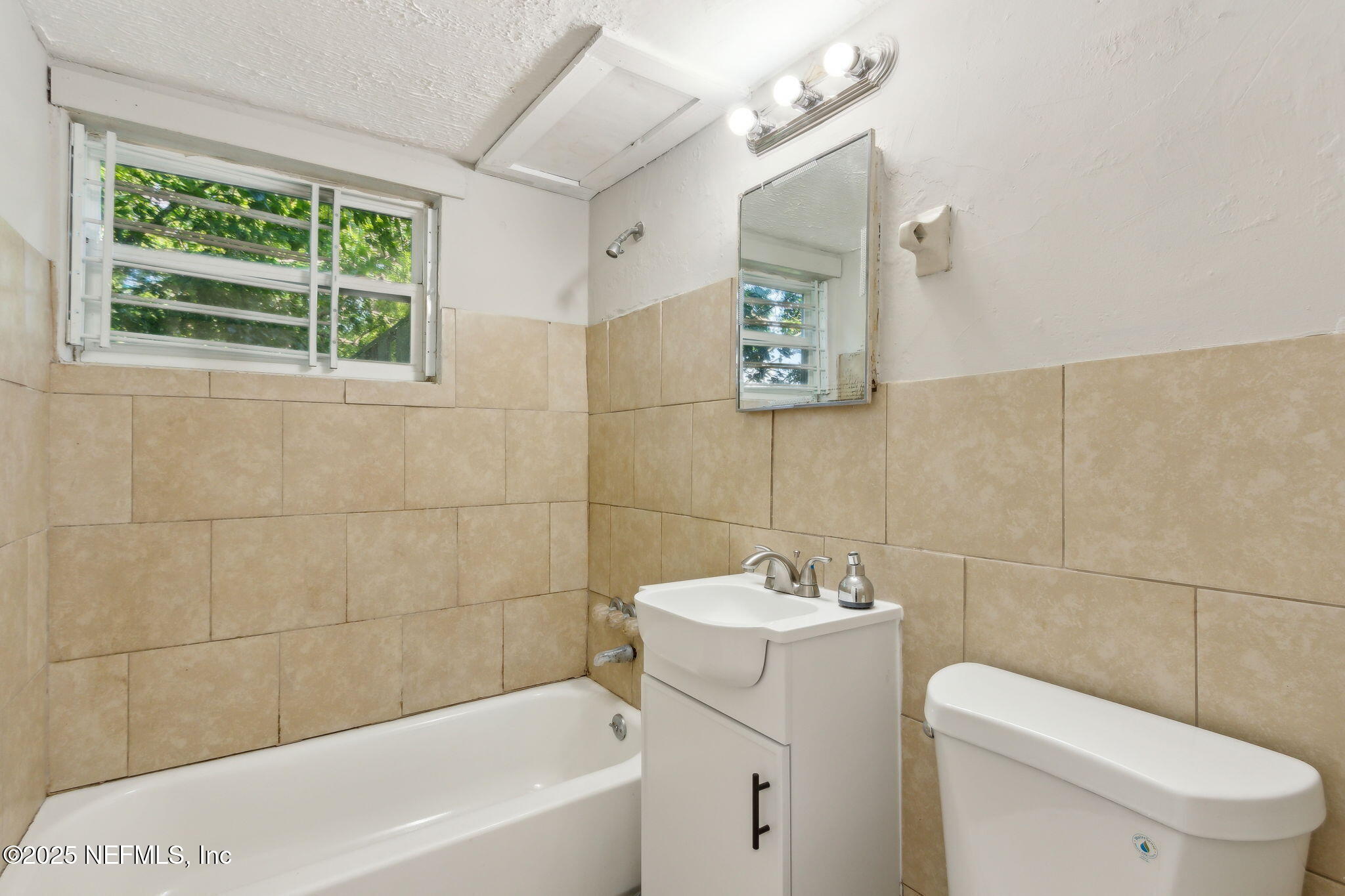 1224 West 18th Street, Unit 4 Jacksonville, FL 32209 - Photo 12 of 14 a bathroom with a sink a toilet and shower