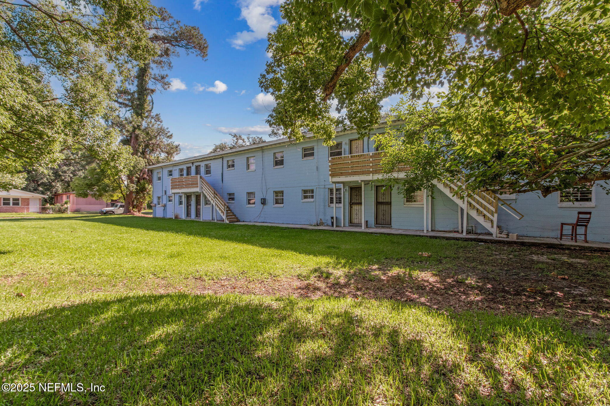 1224 West 18th Street, Unit 4 Jacksonville, FL 32209 - Photo 14 of 14 a view of a house with a big yard and large trees