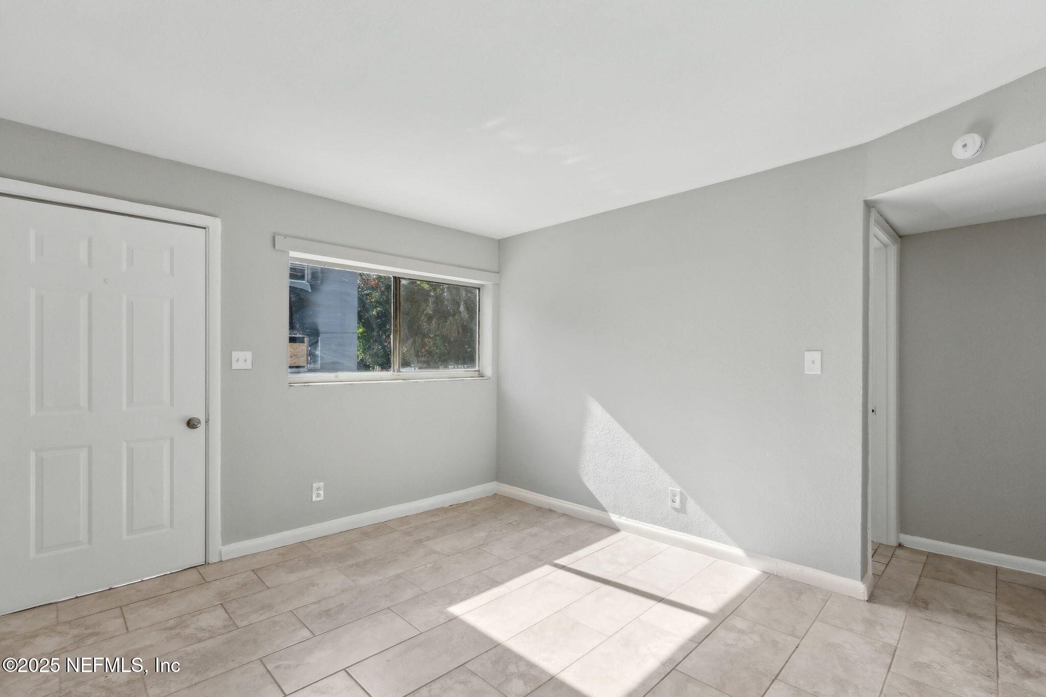 1224 West 18th Street, Unit 4 Jacksonville, FL 32209 - Photo 3 of 14 a view of an empty room with window and stairs