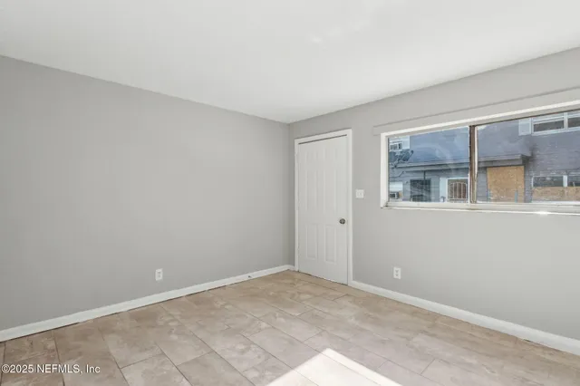 a view of an empty room with a window