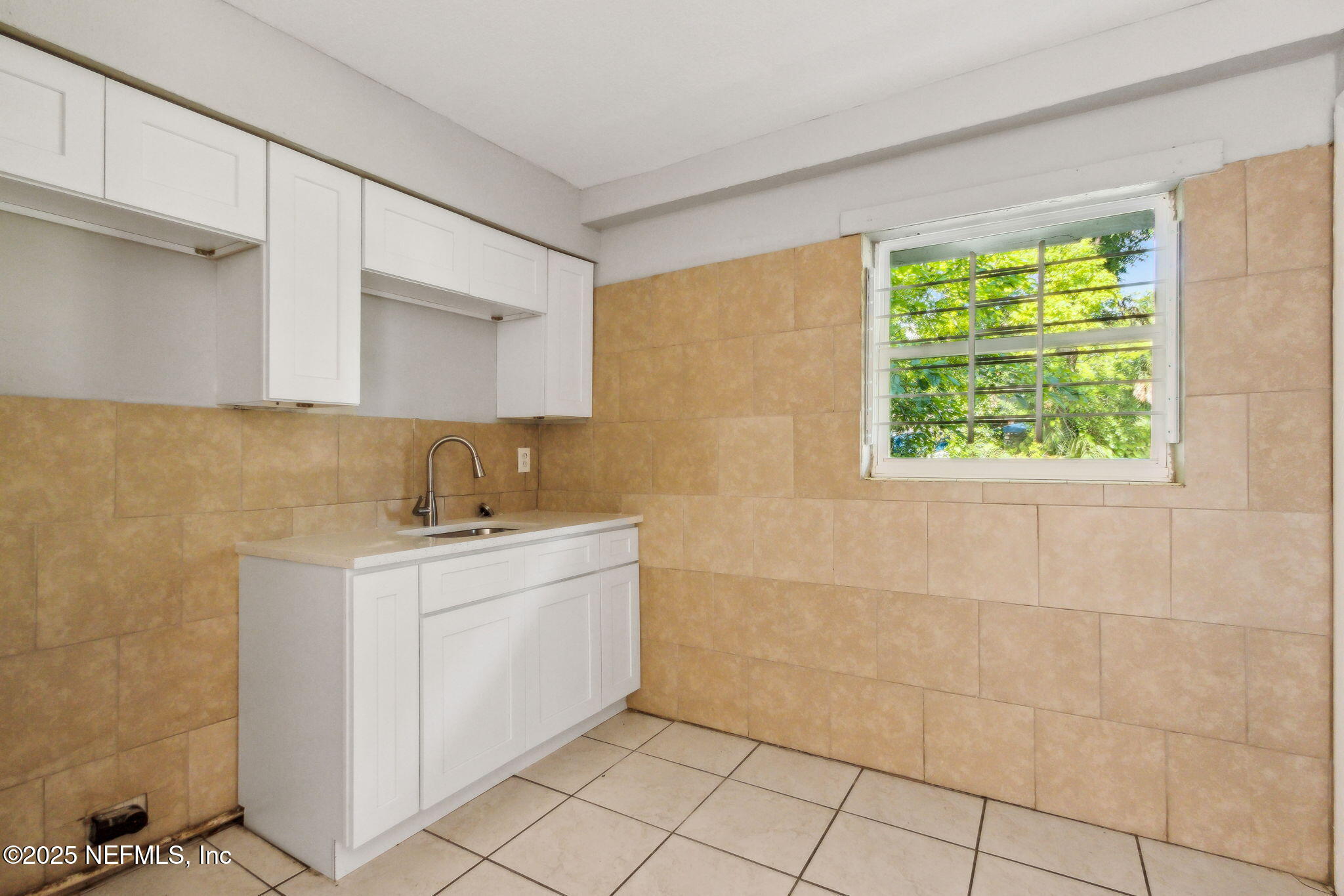 1224 West 18th Street, Unit 4 Jacksonville, FL 32209 - Photo 6 of 14 a utility room with a sink a cabinetry and a window