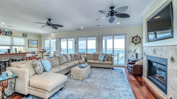a living room with furniture a fireplace and a flat screen tv