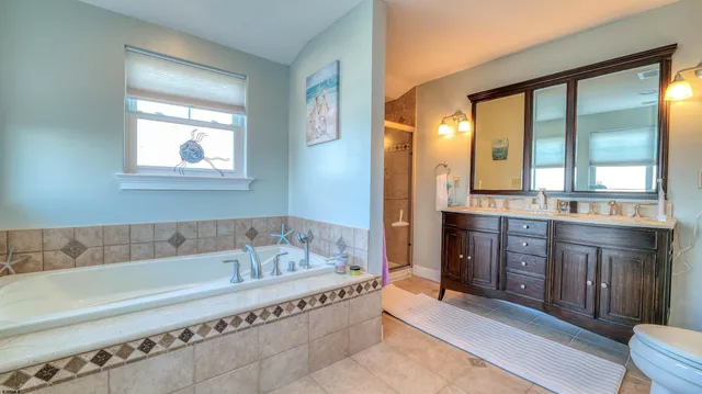 a spacious bathroom with a granite countertop tub sink and mirror