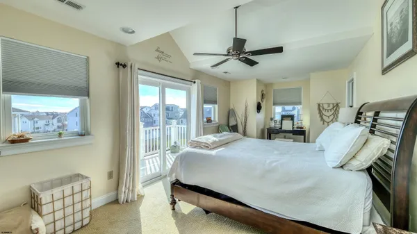 a bedroom with a bed mirror and window