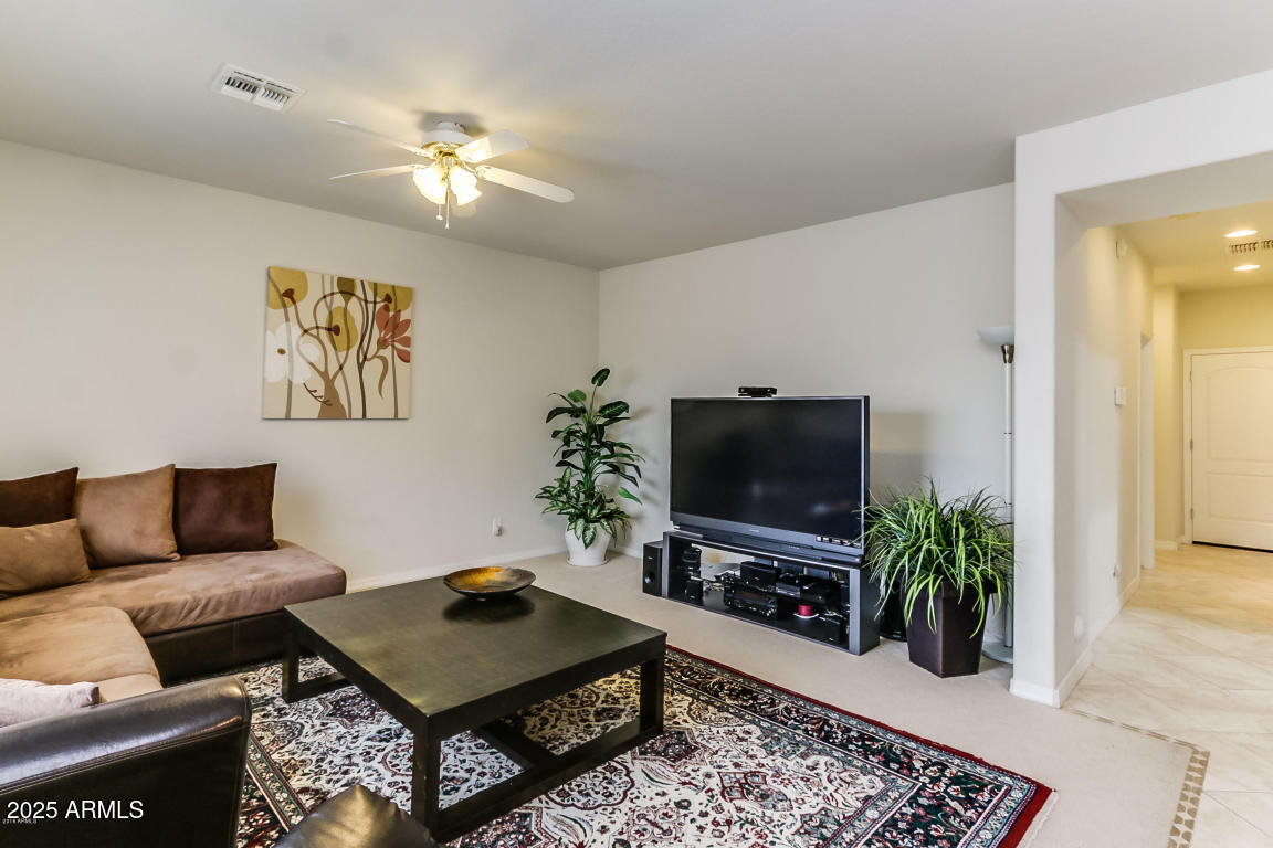 1827 West Black Hill Road Phoenix, AZ 85085 - Photo 11 of 49 a living room with furniture and a flat screen tv