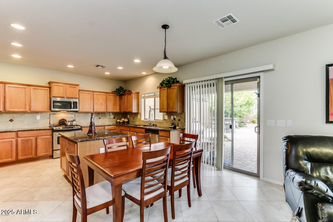 1827 West Black Hill Road Phoenix, AZ 85085 - Photo 13 of 49 a view of a dining room with furniture window and wooden floor