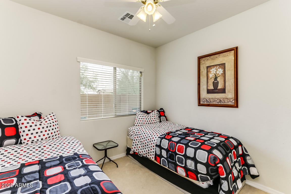 1827 West Black Hill Road Phoenix, AZ 85085 - Photo 27 of 49 a bedroom with a bed and wooden floor