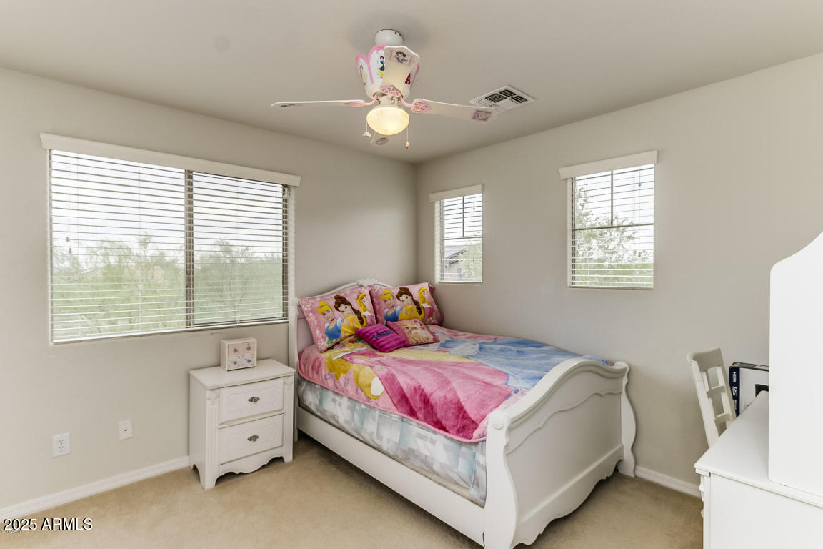 1827 West Black Hill Road Phoenix, AZ 85085 - Photo 33 of 49 a bedroom with a bed and a chandelier