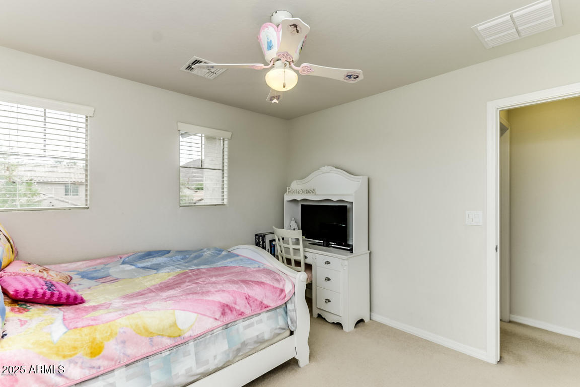 1827 West Black Hill Road Phoenix, AZ 85085 - Photo 34 of 49 a bedroom with a bed and a tv