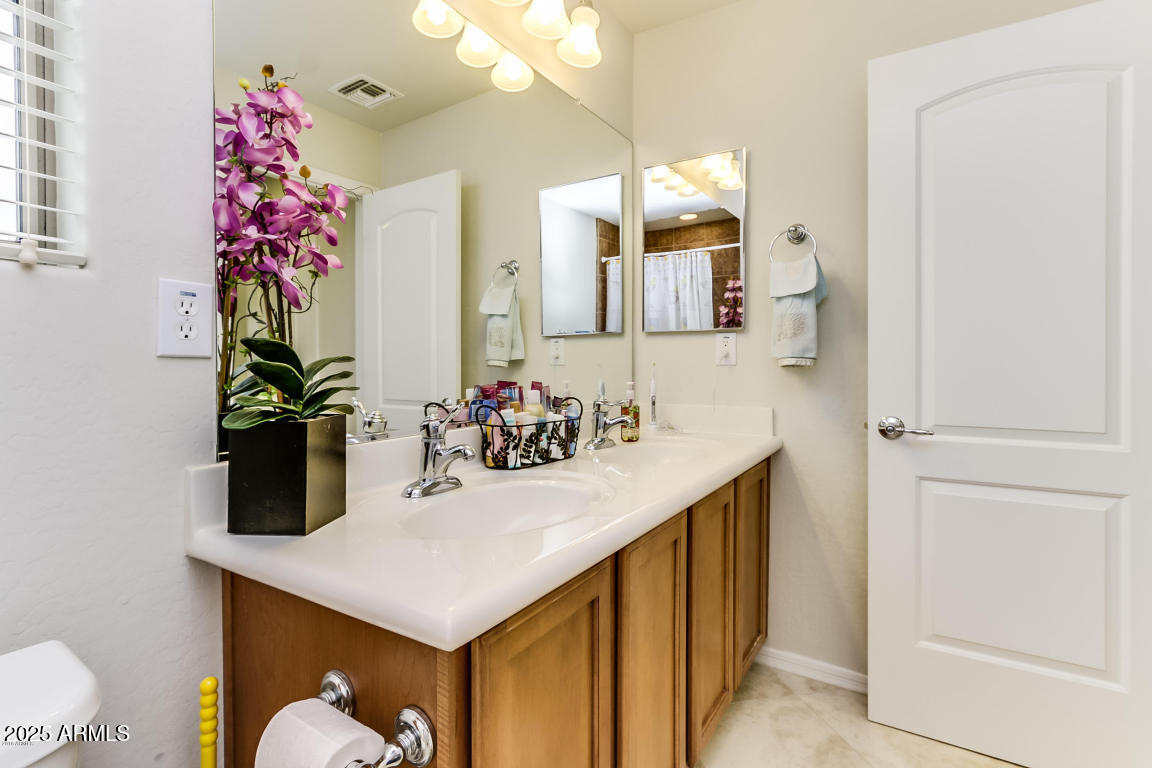1827 West Black Hill Road Phoenix, AZ 85085 - Photo 35 of 49 a bathroom with a sink vanity and a mirror