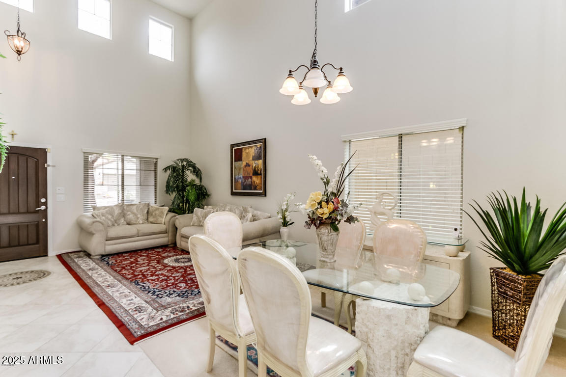 1827 West Black Hill Road Phoenix, AZ 85085 - Photo 8 of 49 a living room with furniture a chandelier and a rug