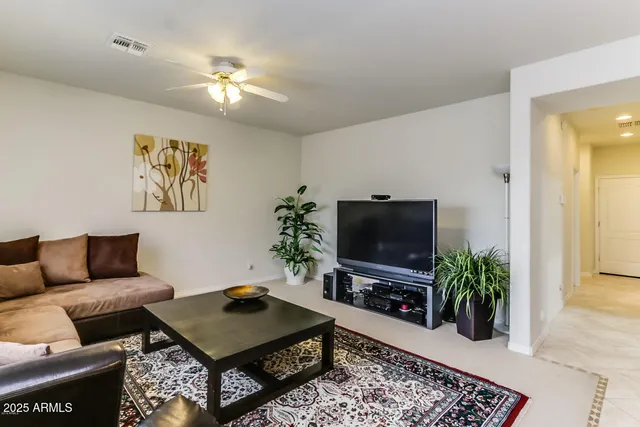 a living room with furniture kitchen view and a large window