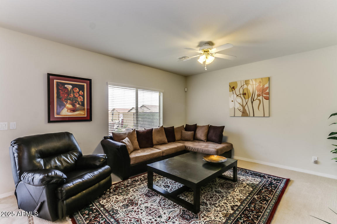 1827 West Black Hill Road Phoenix, AZ 85085 - Photo 10 of 49 a living room with furniture and a rug