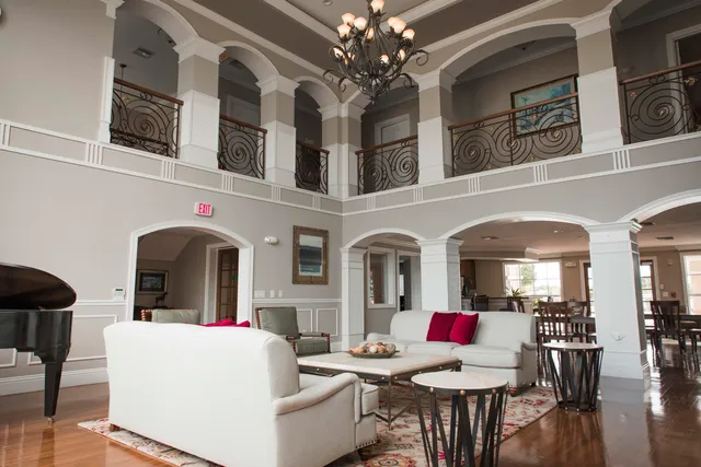 a living room with furniture and a chandelier