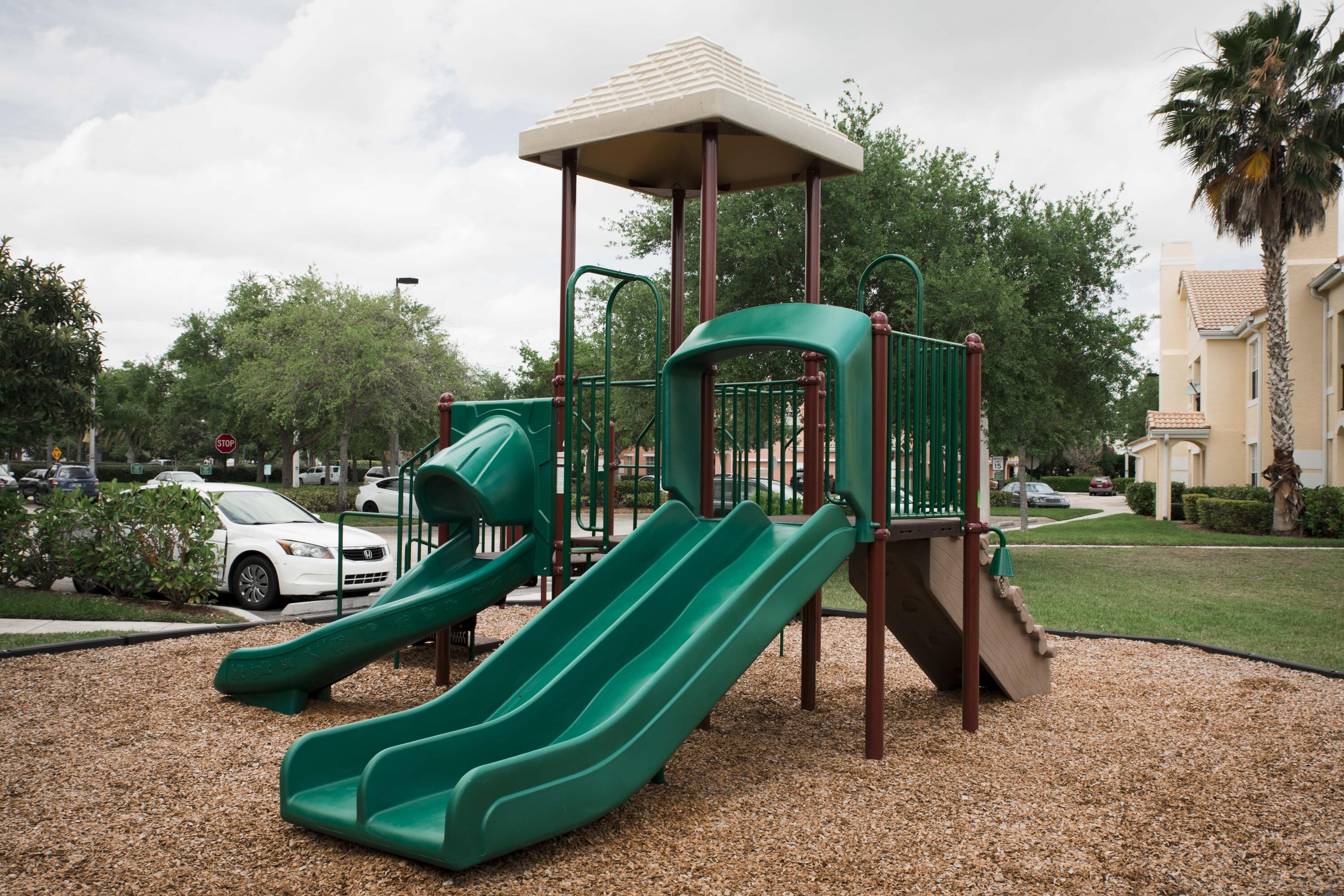 118 Southwest Peacock Boulevard, Unit 101 Port St. Lucie, FL 34986 - Photo 37 of 38 an aerial view of a house with garden space and trees