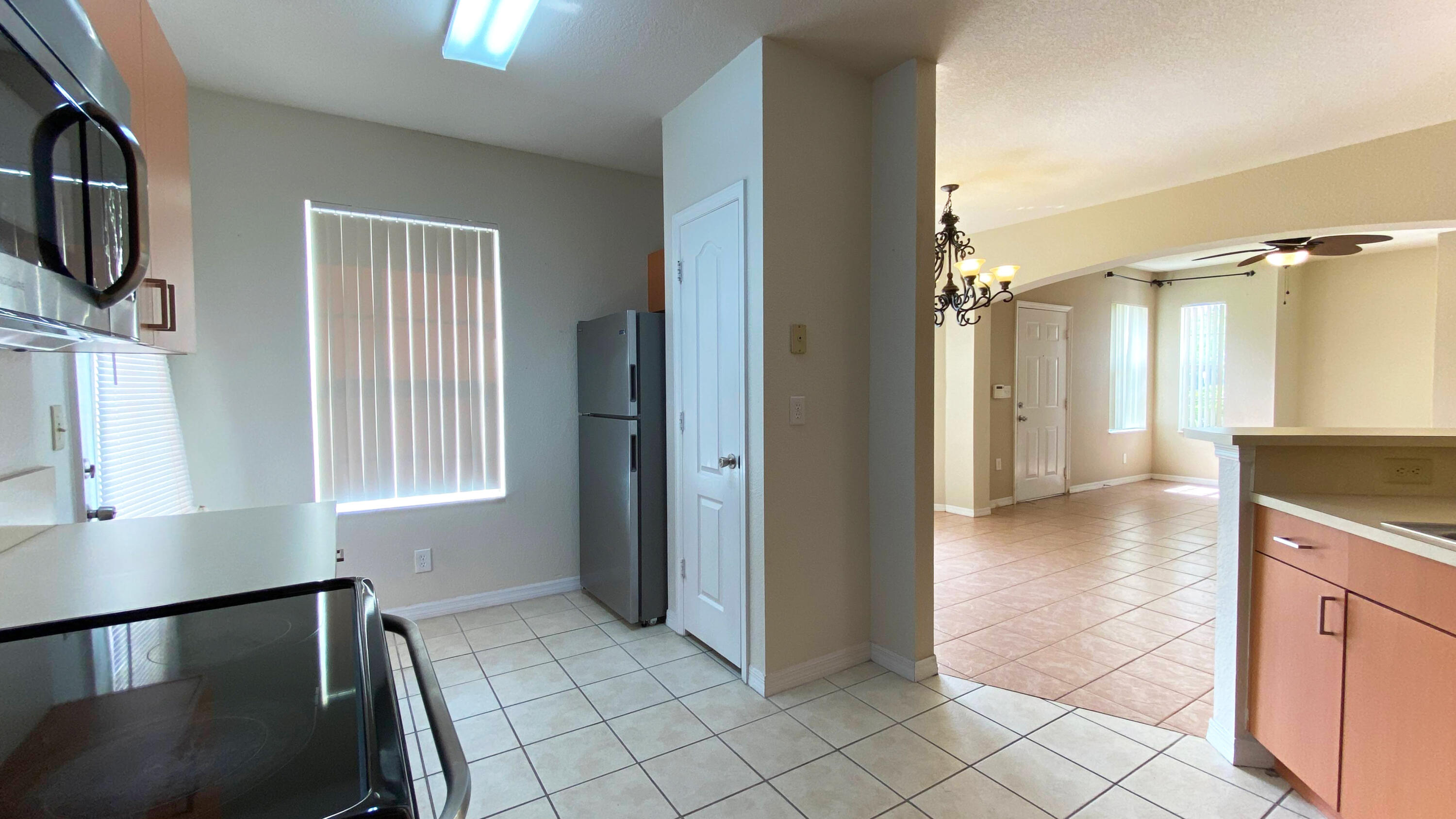 118 Southwest Peacock Boulevard, Unit 101 Port St. Lucie, FL 34986 - Photo 6 of 38 a view of a kitchen with furniture and a kitchen