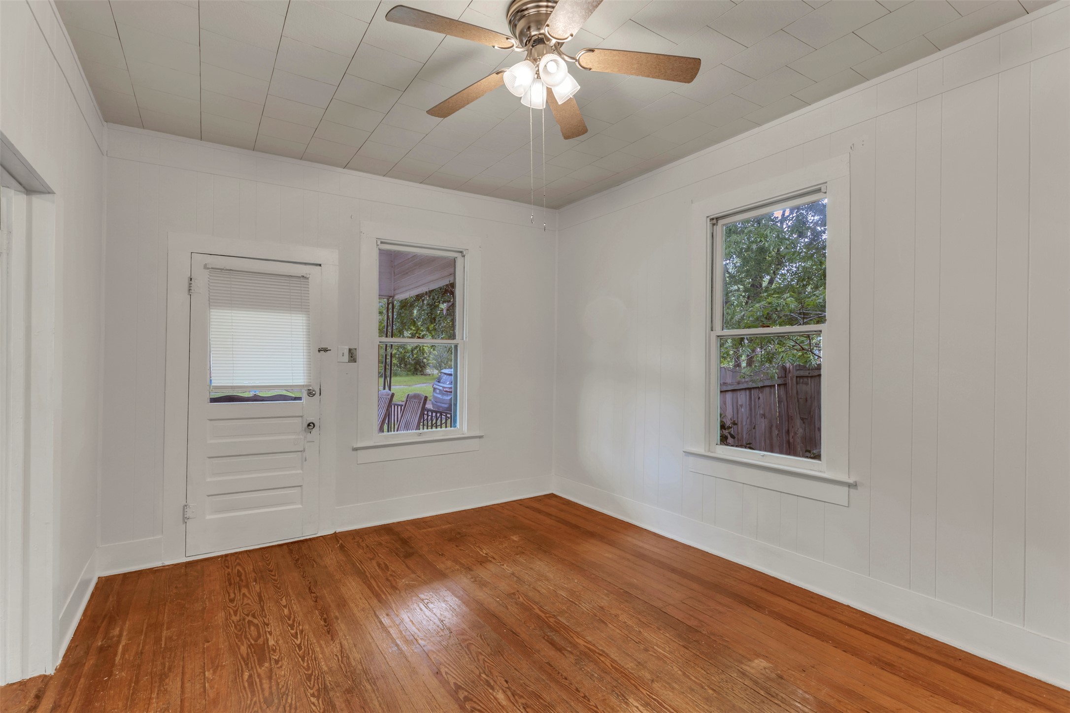 1002 Washburn Street Taylor, TX 76574 - Photo 9 of 29 This room features hardwood floors, white paneled walls, and a white paneled ceiling